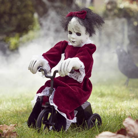 animated halloween prop of a scary ghost child on a bike