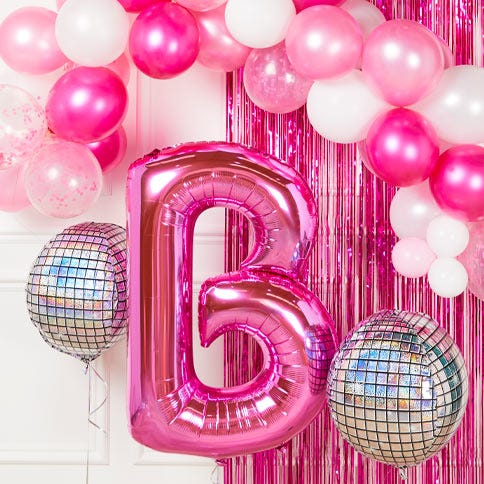 Pink foil B balloon with inflated disco balls and pink balloon arch