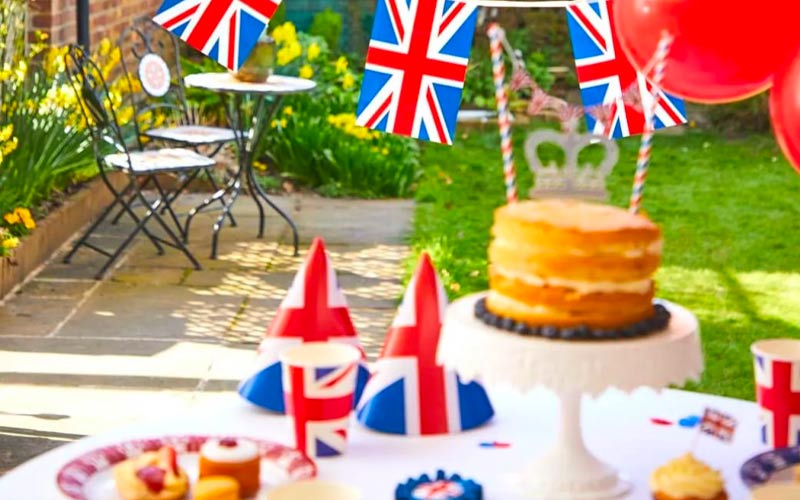 Jubilee street party table display with union jack decorations and cakes