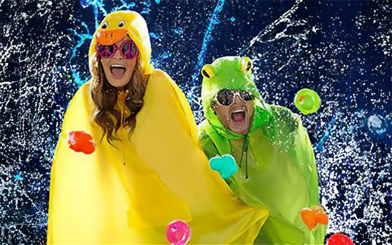 A woman in yellow duck poncho and man in green frog poncho