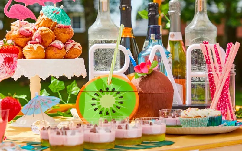 Summer party deserts on a table with drinks in the background