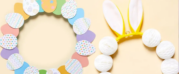 Two Easter Wreath decorations placed side by side, one with coloured paper eggs and the other with bunny ears and pom poms